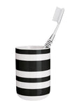 Zahnbürstenbecher mit schwarzen und weißen Querstreifen und Bürste