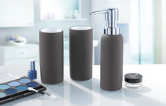 Graues Badset mit Seifenspender und zwei Bechern auf modernem Waschtisch