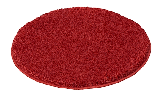 Runder, roter Badteppich mit weicher, flauschiger Oberfläche. Ideal für ein gemütliches Badezimmerambiente.