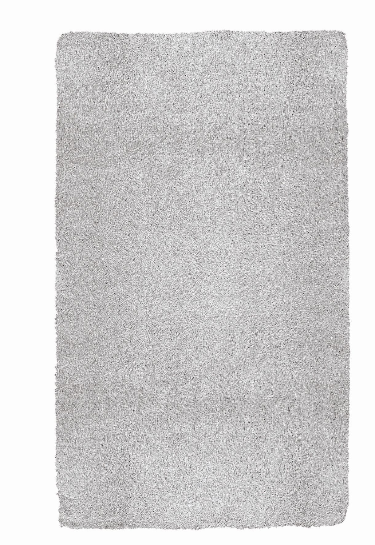 Weißer, rechteckiger Hochflor-Teppich mit weicher, flauschiger Oberfläche für ein gemütliches Wohnambiente.