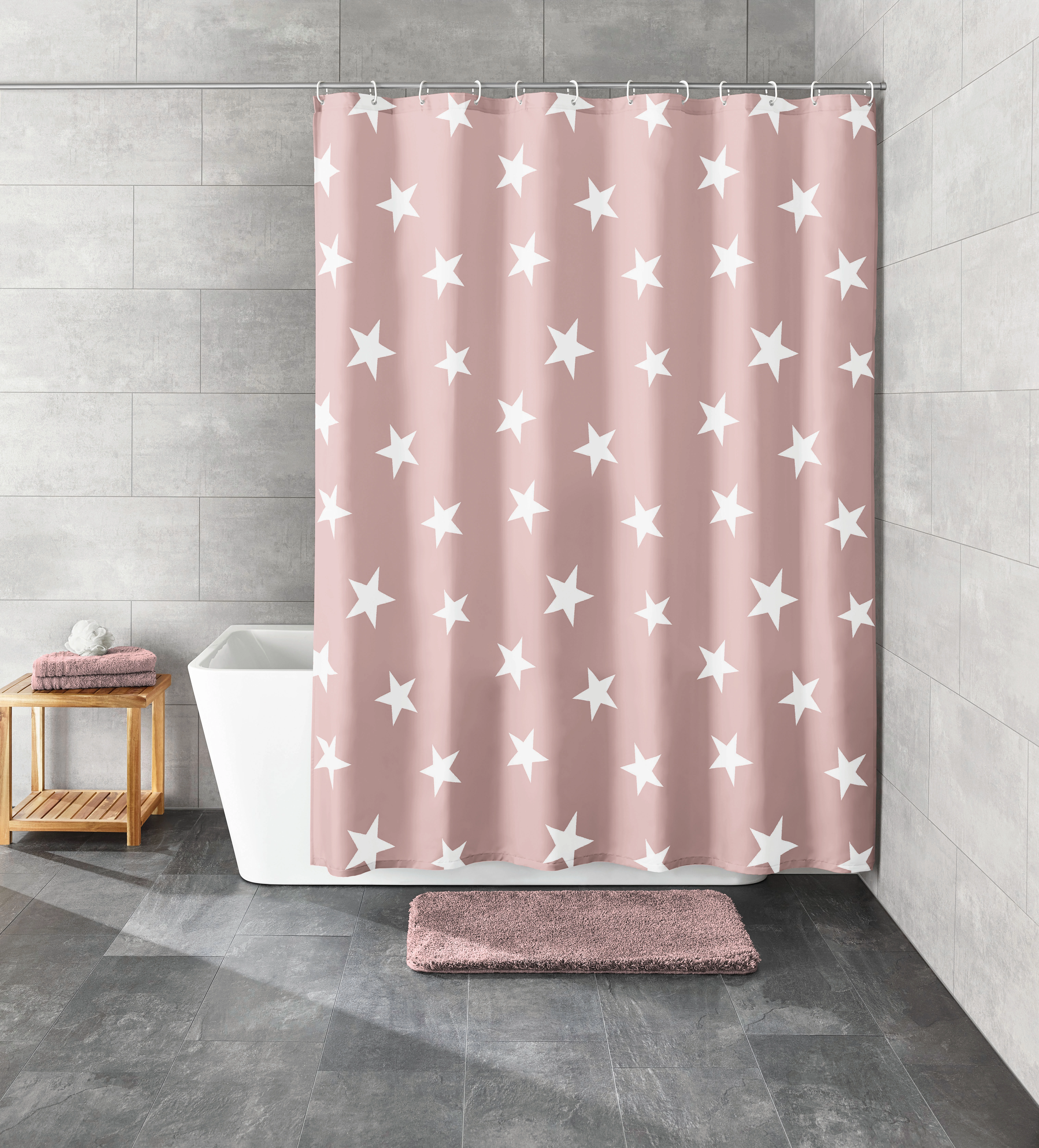 Duschvorhang in Rosa mit weißen Sternen, modernes Badezimmer mit grauen Fliesen, Badewanne und Holzregal.