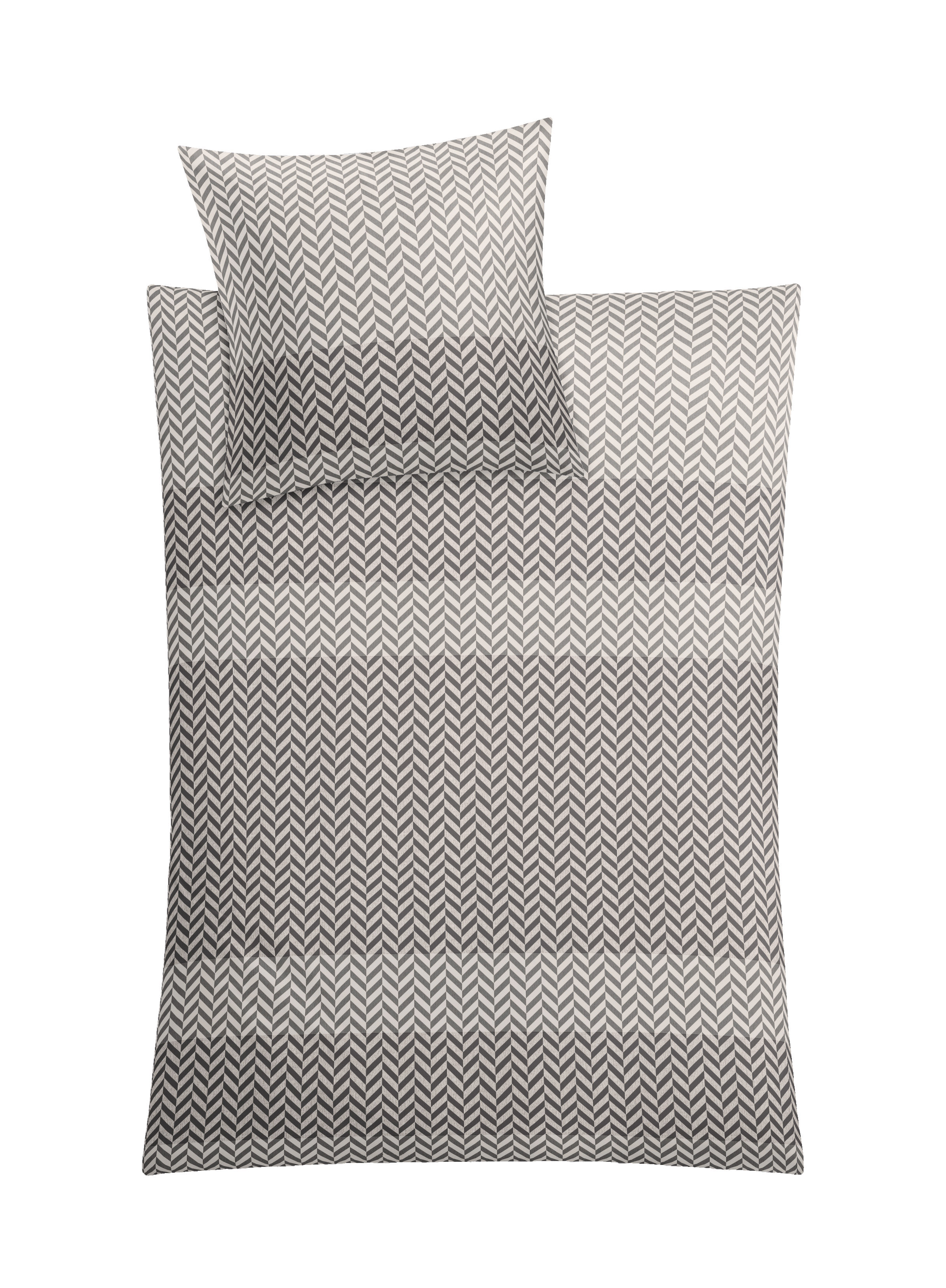 Bettwäsche-Set mit modernem Zickzack-Muster in Schwarz-Weiß, bestehend aus einem Kissenbezug und einem Deckenbezug.