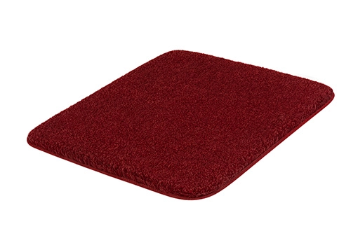 Rote, rechteckige Badematte mit weicher, flauschiger Oberfläche. Ideal für Badezimmer und Wellnessbereiche.