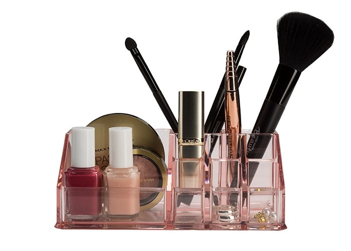 4004478302952 Transparenter, rosafarbener Kosmetik-Organizer mit verschiedenen Fächern, gefüllt mit Make-up-Produkten und Accessoires.
