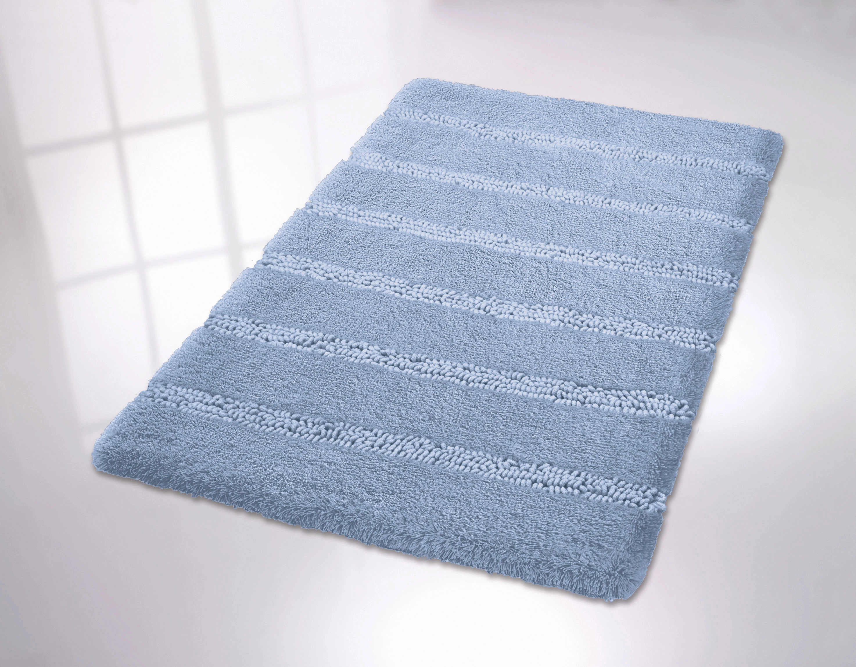 Weicher, hellblauer Badteppich mit Streifenmuster, ideal für ein gemütliches Badezimmerambiente.