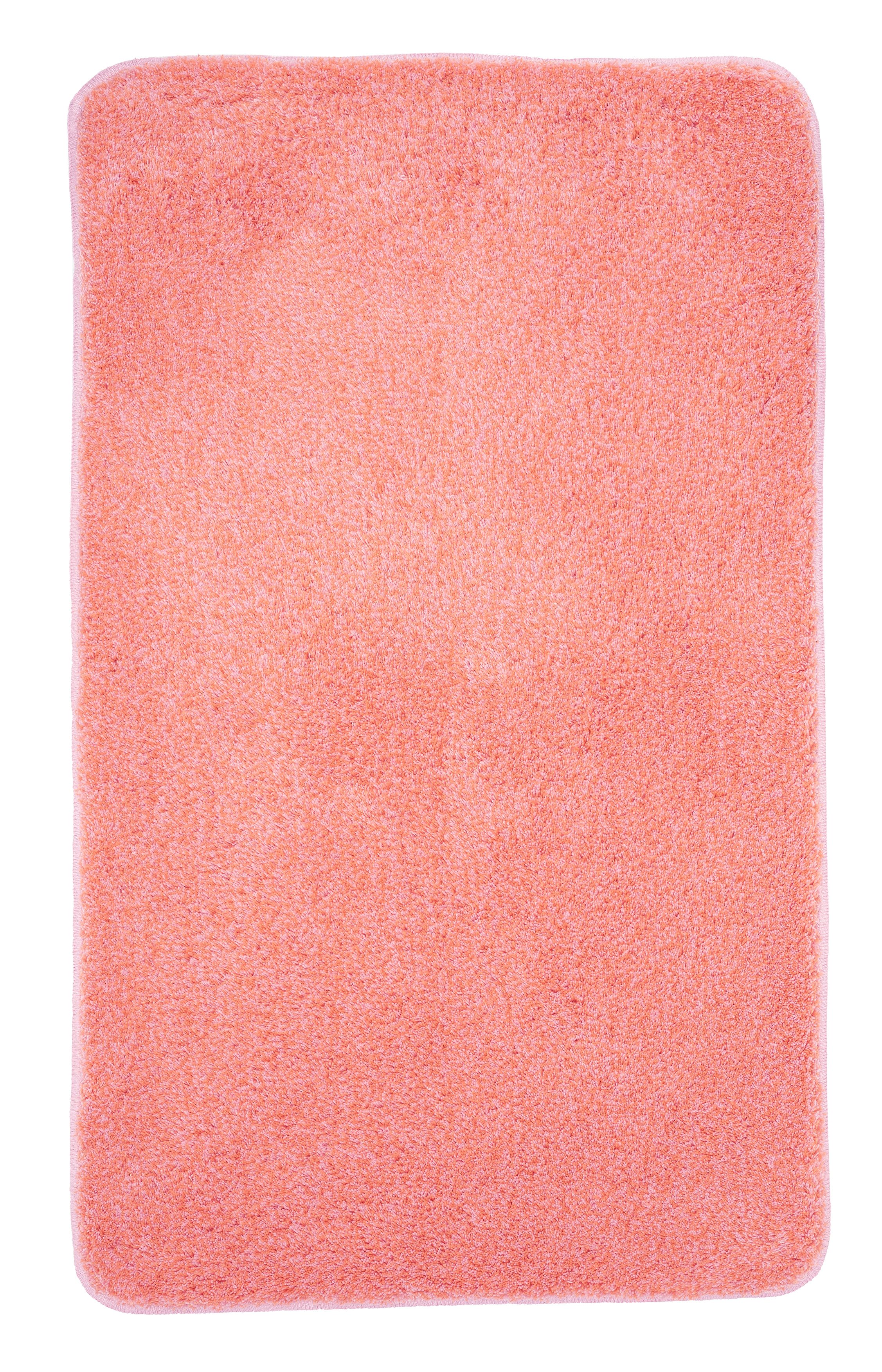 Weiche, rechteckige Badematte in leuchtendem Korallenrot, ideal für ein gemütliches und stilvolles Badezimmer.