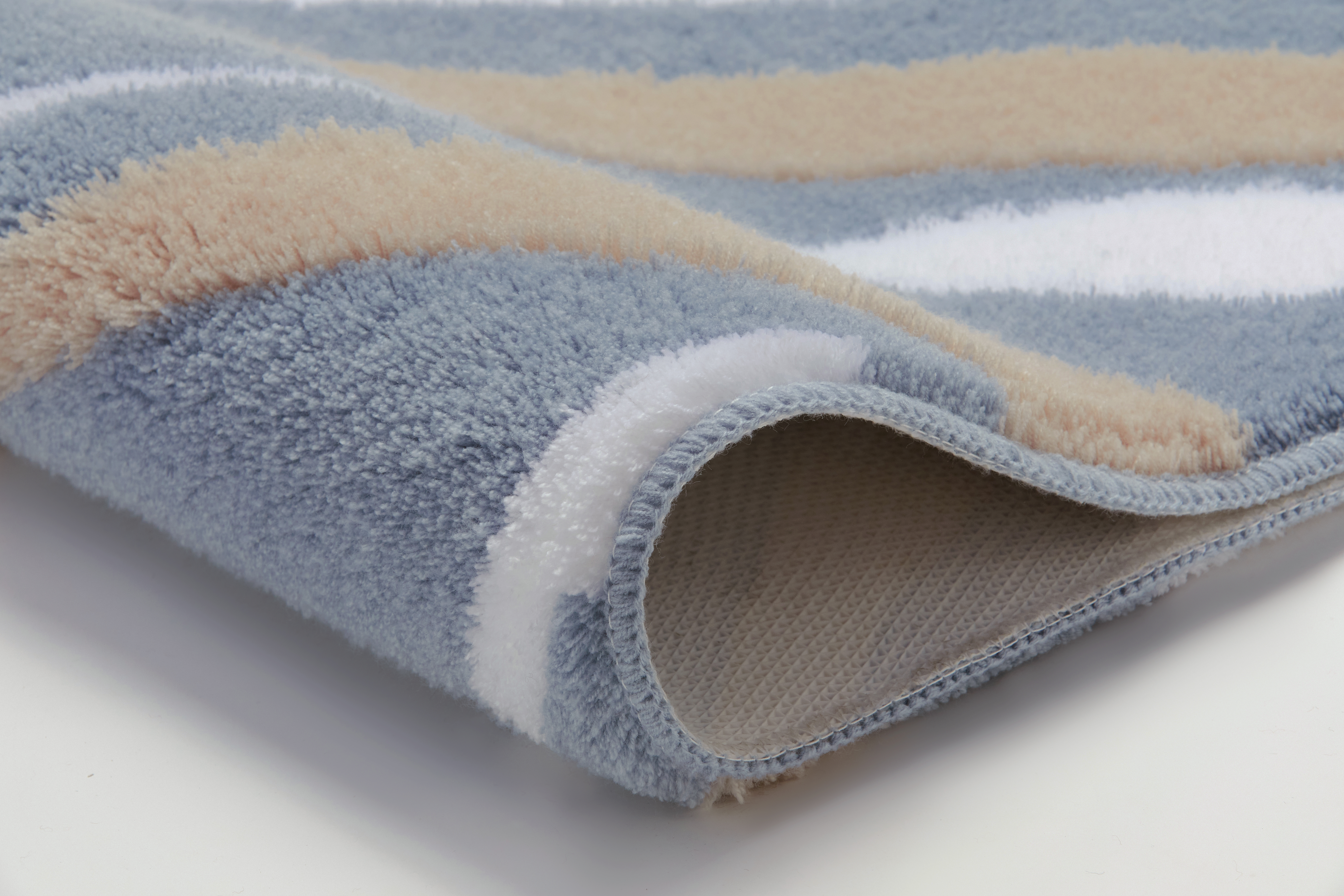 Weicher Badteppich in Blau, Beige und Weiß mit rutschfester Unterseite, ideal für ein gemütliches Badezimmer.